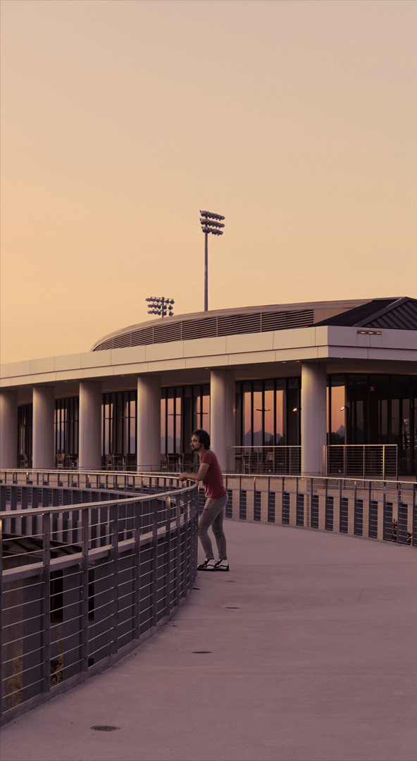 Man Posing On A Bridge At Twilight