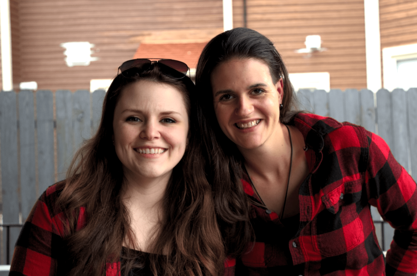 Two Friends Smiling Into The Camera