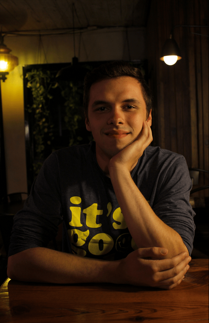 Man At A Coffee Shop Smiling Into the Camera